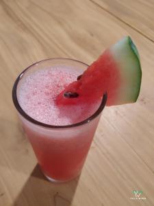 a drink with a piece of watermelon in a glass at Yala wind in Tissamaharama