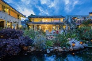 a house with a garden in front of it at Rose Garden Lijiang in Lijiang