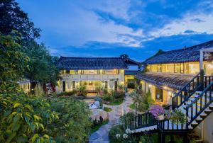 an estate with a garden and a house at Rose Garden Lijiang in Lijiang