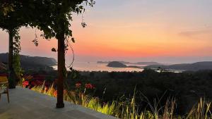 a view of the ocean at sunset from a house at Lobster Bay Lombok in Awang