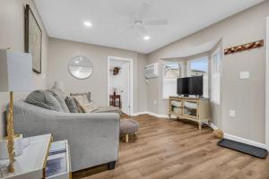 a living room with a couch and a tv at Seaside Cottage: A 'MyShoreCottage' Property in Seaside Heights