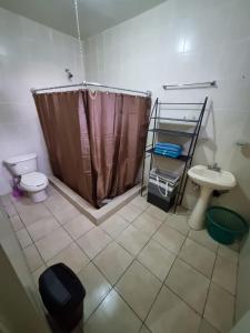 a bathroom with a shower and a toilet and a sink at Departamento Victoria in Saltillo