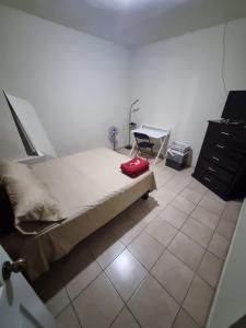 a bedroom with a bed and a desk and a chair at Departamento Victoria in Saltillo