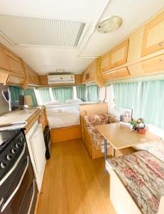 a small kitchen and living room in an rv at Happy Farm Village in Mae Taeng