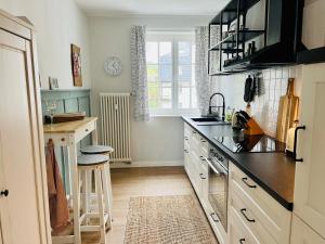 a kitchen with a sink and a counter top at Traumwohnung mit Stadthafen-Panorama! Zwei Schlafzimmer, Parkplatz in Rostock