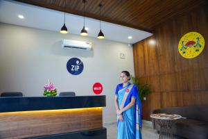 a woman standing in the lobby of a restaurant at Zip By Spree Hotels Bhopal in Bhopal