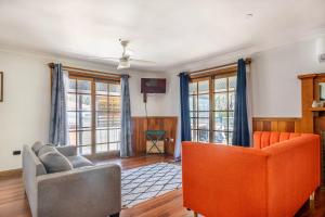 a living room with two chairs and a couch at Swan Lake Escape in Sussex inlet