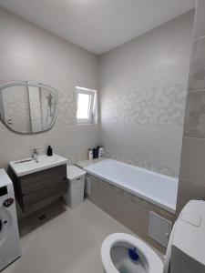 a bathroom with a tub and a toilet and a sink at FLH - AntHome in Sibiu +16 photos
