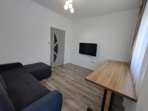 a living room with a couch and a table at FLH - AntHome in Sibiu