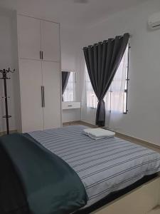 a bedroom with a large bed with a window at 18Homestay @ Temerloh in Temerloh