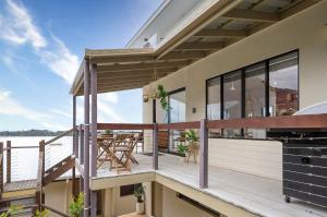 a balcony of a house with a view of the water at Sheket in Gold Coast