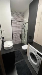 a bathroom with a toilet sink and a washing machine at CityCenterLuxuryApartmentI11-35 in Bielsko-Biała