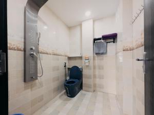 a bathroom with a blue toilet and a shower at Home Sweet Home in Tây Ninh