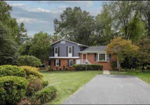 a house with a driveway in front of a yard at Guest house for group of 8 people in Charlottesville