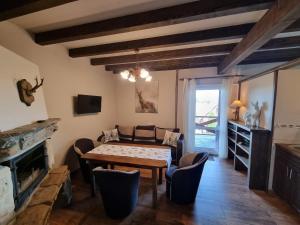 La Merveille في سولينا: غرفة معيشة مع طاولة وكراسي ومدفأة