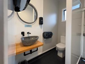 a bathroom with a sink and a toilet at Kiwi Cabins in Tapu