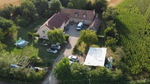 an aerial view of a house with cars parked in a yard at Corbon in Vivoin