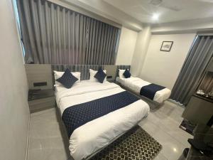 Postel nebo postele na pokoji v ubytování HOTEL ASIANA SKY Motera Ahmedabad