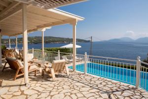 a patio with a view of the water at Ionian Calm Villas in Vasiliki