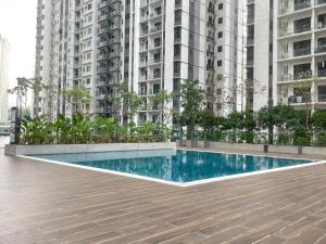 a swimming pool in front of some tall buildings at Local Living, Global Comfort 4 Pax Bangsar South in Kuala Lumpur