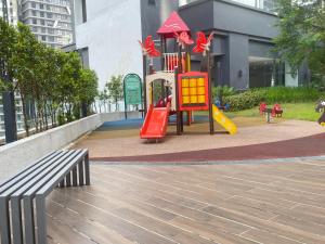 a playground with a slide and a bench in a city at Local Living, Global Comfort 4 Pax Bangsar South in Kuala Lumpur