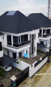a large white house with a black roof at Luxury 4 bedroom duplex in Lekki