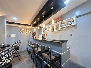 a bar with chairs and a counter in a restaurant at D' Beach Resort in Puerto Princesa City