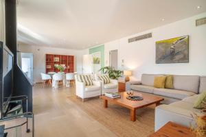a living room with a couch and a table at Penthouse La Victoria in Cielo de Bonaire 