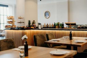 a restaurant with two tables and chairs and a counter at Hotel Crystal in Saarbrücken