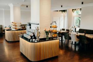 a restaurant with tables and chairs and flowers on display at Hotel Crystal in Saarbrücken