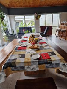 a long table with food on it in a living room at CHAMBRES ET TABLES D'HOTE DU VOYAGEUR in La Plaine des Palmistes