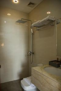 a bathroom with a tub and a toilet and a sink at Eastland Hotel And Residences in Cebu City