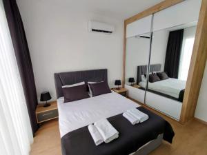a bedroom with a bed and a large mirror at Luxury Four Seasons Life Sea Front Apartment 6-C in Boğaz +37 photos