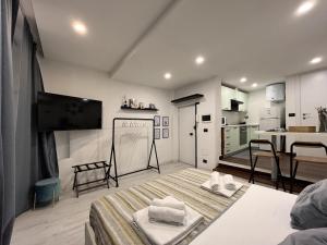 a living room with a bed and a kitchen at Giano Host - Strada Nuova in Genova +6 photos