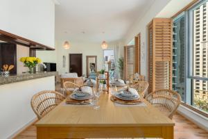 a dining room with a wooden table and chairs at Boutique Apartment Sea Views - Dubai Marina in Dubai