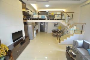 a large living room with a staircase and a living room at WAIFIDEN Duplex Hotel Apartment Zhongyong Jinyu Branch in Guangzhou