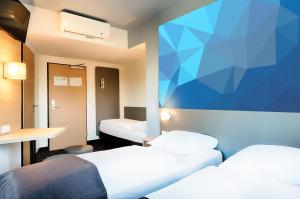 Llit o llits en una habitació de B&B Hotel Stuttgart-Vaihingen