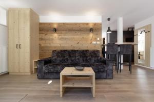 a living room with a couch and a table at Dolomite Apartments Winklwiese 6&7 in San Candido