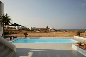 a swimming pool with a view of the ocean at Isychos House in Mikri Vigla