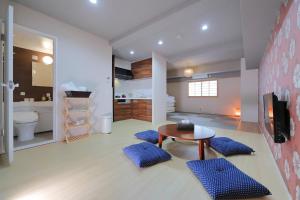 ein Bad mit einem Tisch und blauen Kissen in einem Zimmer in der Unterkunft HOTALU Universal Vacation - Kan in Osaka