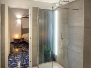 a shower with a glass door in a bathroom at Lucente Rooms & Suites in Ugento