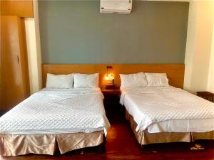 two beds sitting next to each other in a room at THỦY TÚ HOTEL in Hanoi