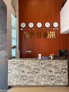 a counter with four clocks on a wall at THỦY TÚ HOTEL in Hanoi