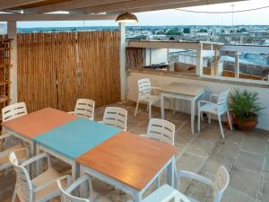 a patio with tables and chairs on a roof at Lucente Rooms & Suites in Ugento