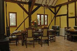 a dining room with a table and chairs in it at Upper Neatham Mill in Alton