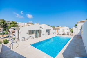a swimming pool in the backyard of a house at Can Botana Casa 8 - By Dream Villas Pollensa in Cala de Sant Vicenc