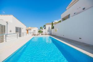 a swimming pool in the backyard of a house at Can Botana Casa 8 - By Dream Villas Pollensa in Cala de Sant Vicenc