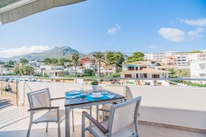 a table and chairs on a balcony with a view at Can Botana Casa 8 - By Dream Villas Pollensa in Cala de Sant Vicenc
