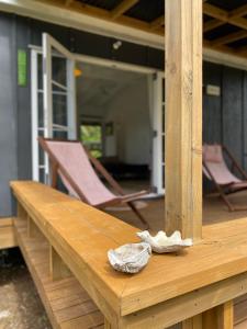 a wooden table with two chairs on a porch at David's Fale, Alofi, Niue in Alofi