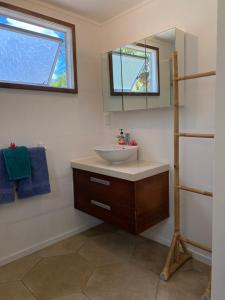 a bathroom with a sink and a mirror at David's Fale, Alofi, Niue in Alofi